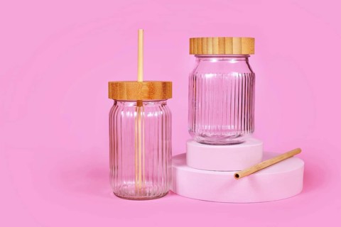 Natural material jars with drinking straws made from glass, wood and bamboo