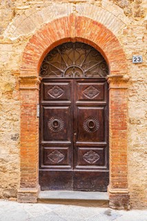 Ornate round arch front door, Montalcino