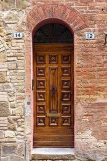 Ornate round arch front door, Montalcino