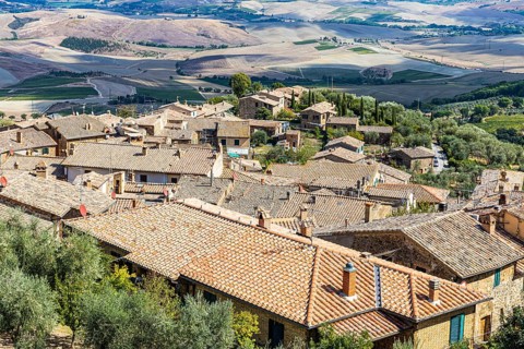 Above the rooftops of Montalcino, view of the Val dOrcia valley