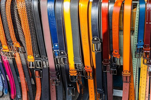 Coloured belts at a stall at the weekly market market in Buonconvento, Val dOrcia