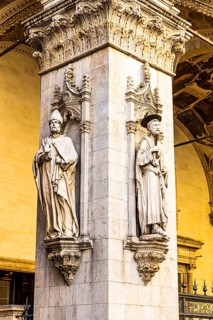 Stone figures on a support in the historic centre, Siena