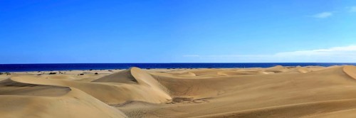 The dunes of Playa Del Ingles with a view of the Atlantic Ocean. San Bartolome de Tirajana, Gran Canaria