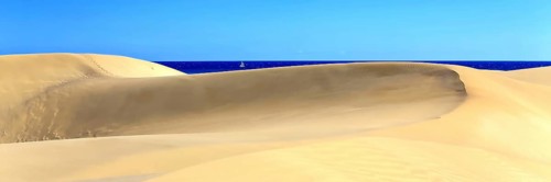 The dunes of Playa Del Ingles with a view of the Atlantic Ocean. San Bartolome de Tirajana, Gran Canaria