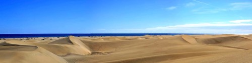 The dunes of Playa Del Ingles with a view of the Atlantic Ocean. San Bartolome de Tirajana, Gran Canaria