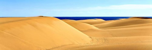 The dunes of Playa Del Ingles with a view of the Atlantic Ocean. San Bartolome de Tirajana, Gran Canaria