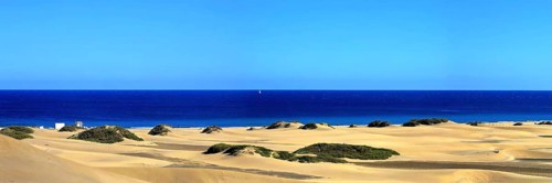 The dunes of Playa Del Ingles with a view of the Atlantic Ocean. San Bartolome de Tirajana, Gran Canaria