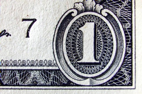 Macro of one dollar note greatly enlarged,
