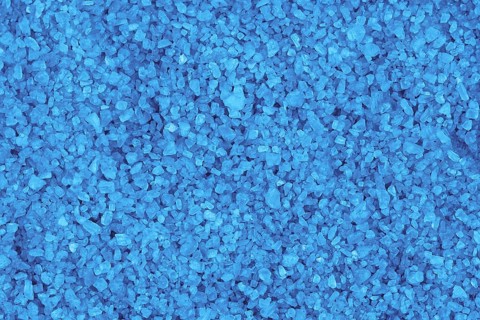 Blue mineral bath salt top view background,