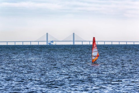 Windsurfers in front of the Oeresund Bridge, Oresundsbroen between Malmoe and Copenhagen