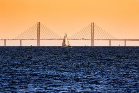 Sailboat in front of the Oeresund Bridge, Oresundsbroen between Malmoe and Copenhagen