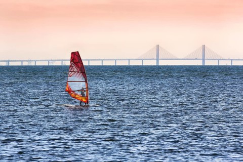 Windsurfers in front of the Oeresund Bridge, Oresundsbroen between Malmoe and Copenhagen