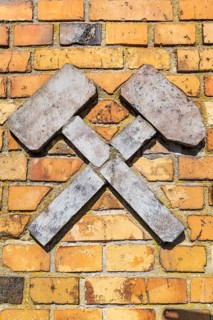 Mining symbol hammer and iron, avenue of construction machinery from opencast lignite mining
