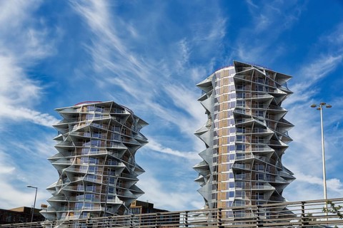 Two dramatically shaped residential towers, high-rises side by side
