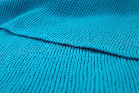 Knitted wool blanket in the colour magenta,