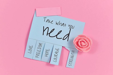 Blue tear-off stub note with text Take what you need and words Love, Freedom