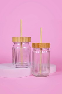 Natural material jars with drinking straws made from glass, wood and bamboo