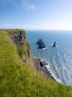 Cliff, rock Reynisdrangar in the water