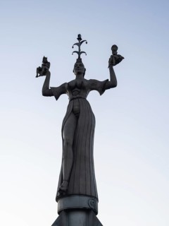 Statue of Imperia at the harbour entrance of Constance in the morning light in front of sunrise, Old Town