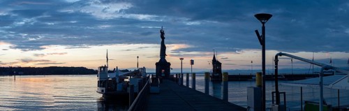 Statue of Imperia at the harbour entrance of Constance in the morning light in front of sunrise, Old Town