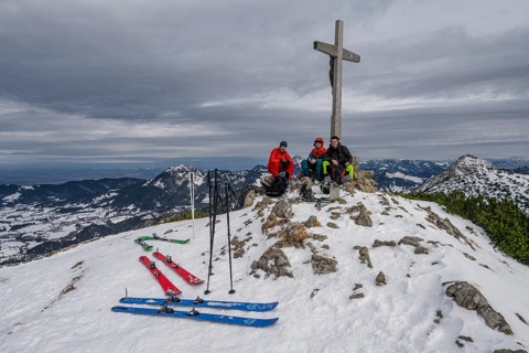 Three ski tourers at the summit of the Jaegerkamp in winter, Bavaria