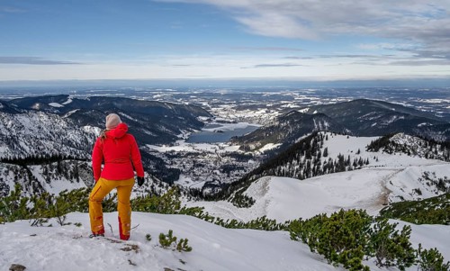 View of Schliersee, ski tourer at the summit of Jaegerkamp in winter