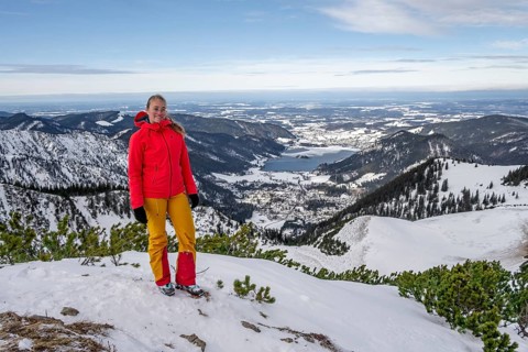 View of Schliersee, ski tourer at the summit of Jaegerkamp in winter