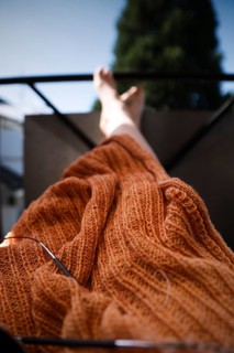 Knitted blanket with knitting needles,