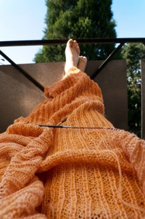 Knitted blanket with knitting needles,