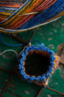 Handwork, knitted sock with knitting needles and wool