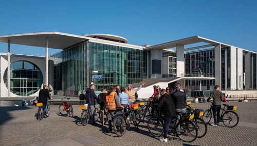 Tourists with bicycle and guide in the Berlin government district, Berlin