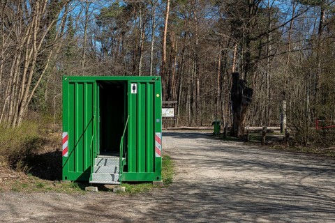 Green toilet container in Tegeler Forst, Berlin