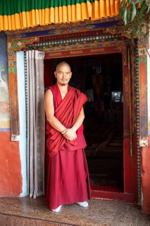 Monk at the entrance to the prayer hall, Diskit Monastery or Deskit Gompa