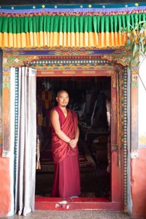 Monk at the entrance to the prayer hall, Diskit Monastery or Deskit Gompa