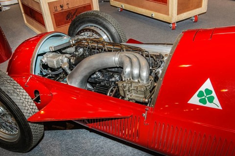 View into engine compartment of historic Italian racing car Alfa Romeo GP Tipo 158 Alfetta first Formal 1 winner 1950 50s, right logo Quadrifoglio four-leaf clover number plate for high-performance Al...