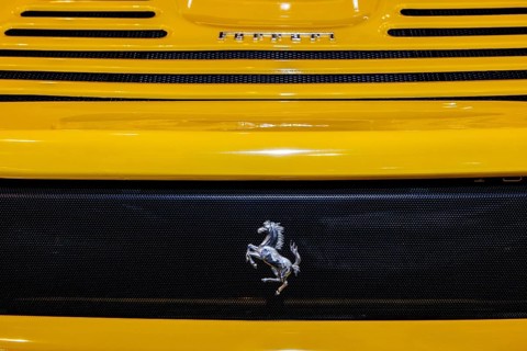 View of rear end of yellow Ferrari with logo Cavallino Rampante jumping horse, Techno Classica fair