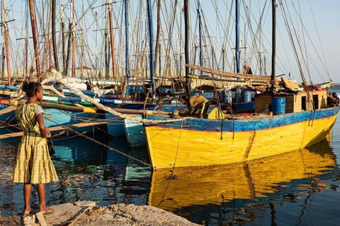 Girl in yellow dress, fishing boats