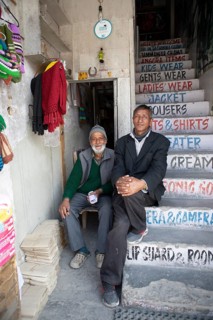 Ladakhi men on a staircase, Main Bazaar Road