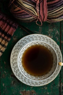 Handmade, Knitted piece with knitting needles and coffee