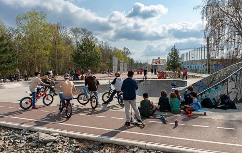Skateboarders and cyclists at a skate pool in the Park am Gleisdreieck in Berlin-Mitte, Berlin