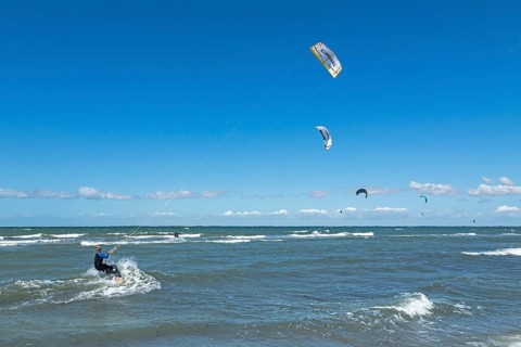 Kitesurfer in front of Graswarder peninsula, Heiligenhafen