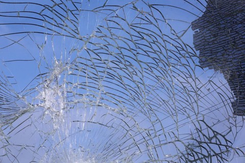 Shattered and broken glass pane with fractures, cracks and shapes
