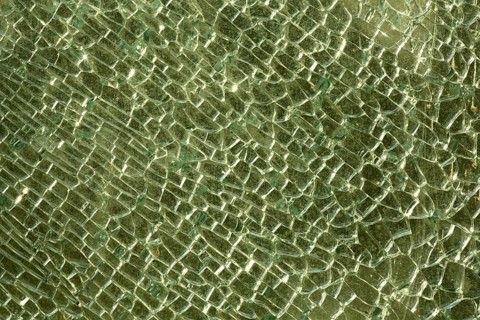 Shattered and broken glass pane with fractures, cracks and shapes