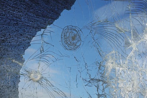 Shattered and broken glass pane with fractures, cracks and shapes
