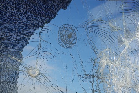 Shattered and broken glass pane with fractures, cracks and shapes