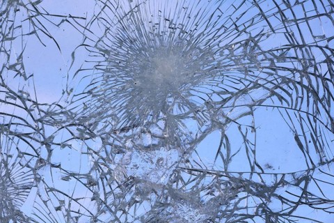 Shattered and broken glass pane with fractures, cracks and shapes