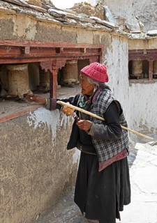 Old Ladkhi woman with prayer wheels, Lamayuru Monastery or Lamayuru Gompa