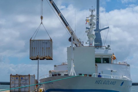 Excursion ship, containers being unloaded by crane