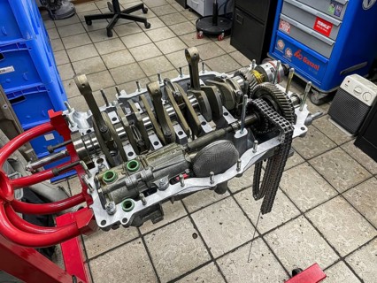 Gearbox for air-cooled engine of historic classic sports car classic car Porsche 911 964 overhauled restored in workshop on rack for assembly assembly rack, Germany