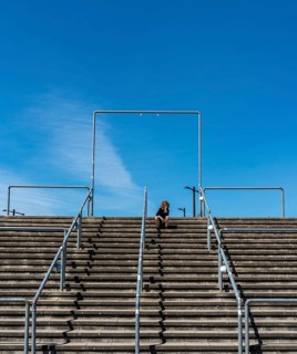 Lone spectator sitting on the steps to the stadium, Graefenhainichen